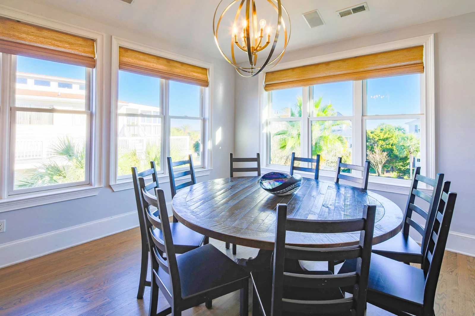 The dining table seats 10 and there are additional stools at the kitchen counter.