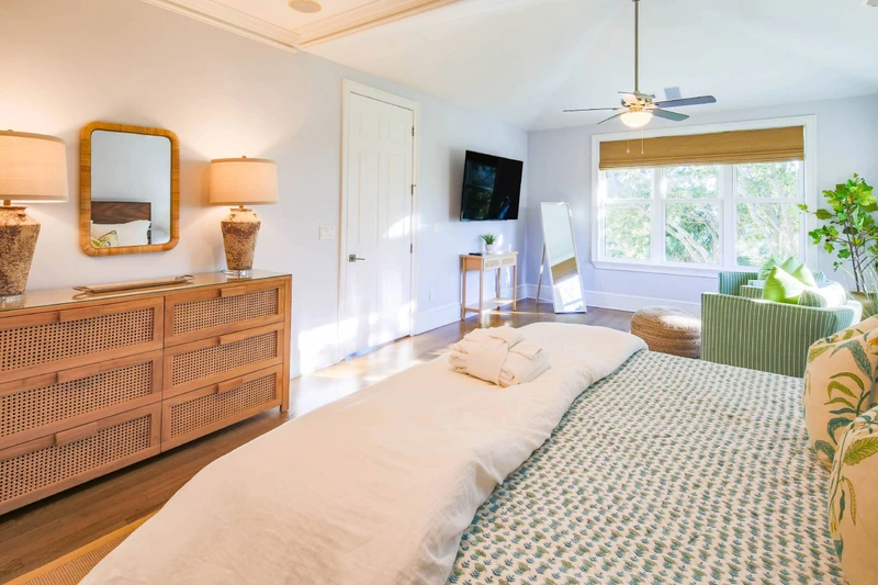 The second level primary suite has a mounted, large screen TV and seating area.