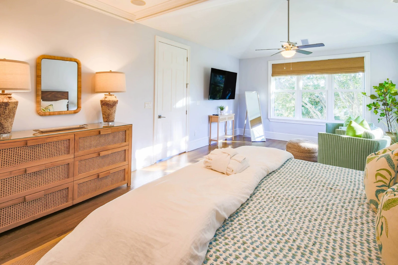 The second level primary suite has a mounted, large screen TV and seating area.