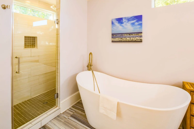 The second level primary en suite bathroom also has a tiled, walk-in shower and a soaking tub.