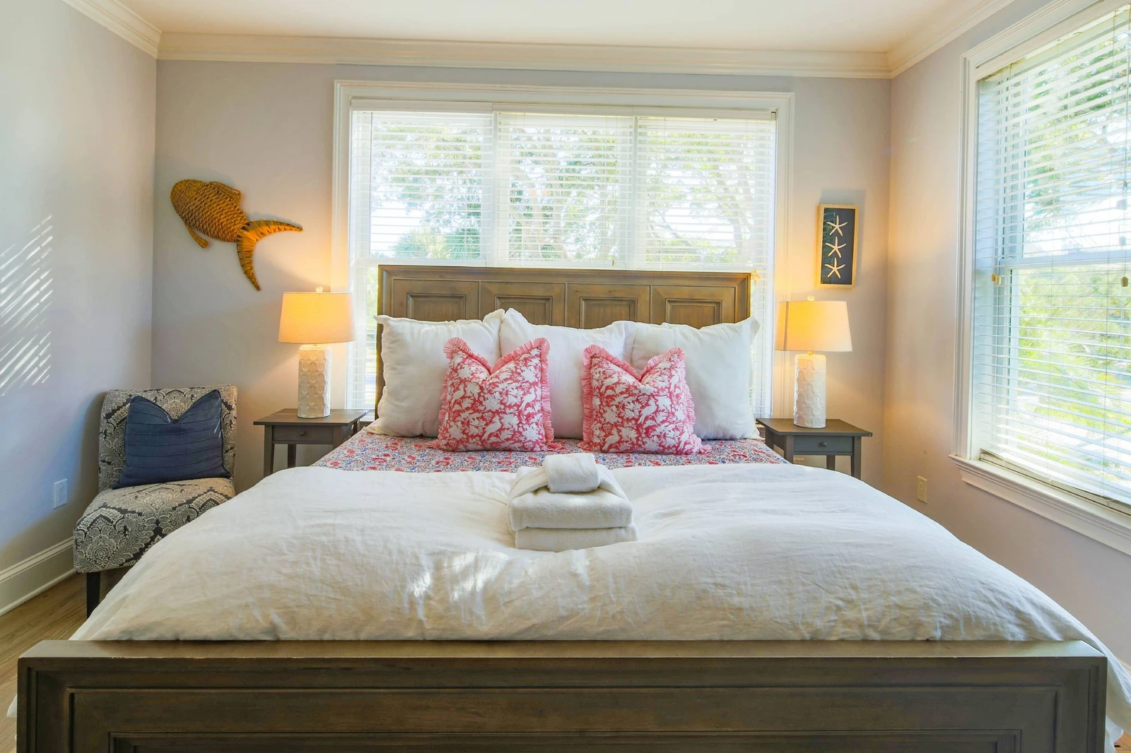 The lower level primary suite also has a chair and lovely natural light through the windows.