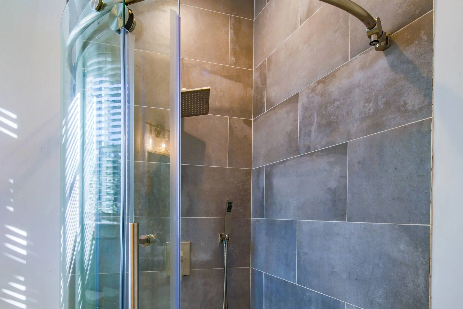 The en suite bathroom also has a tiled, walk-in shower.