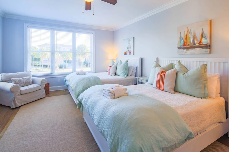 This first floor guest bedroom has two queen beds and access to a Jack & Jill shared bathroom.