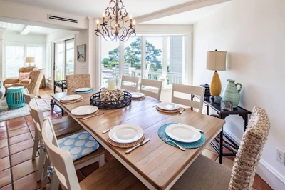 The indoor dining table comfortably seats 8 people.  There are four stools at the kitchen counter.