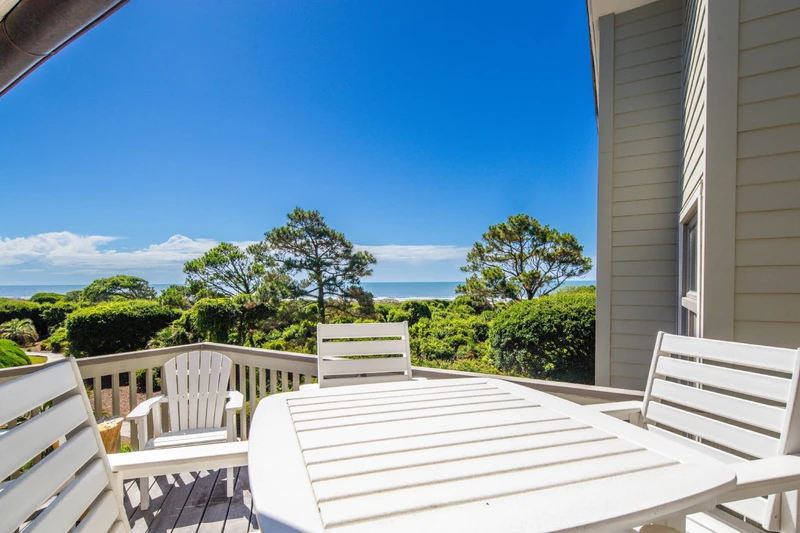 The back deck features these serene ocean views, a high top table & chairs and a seating area.