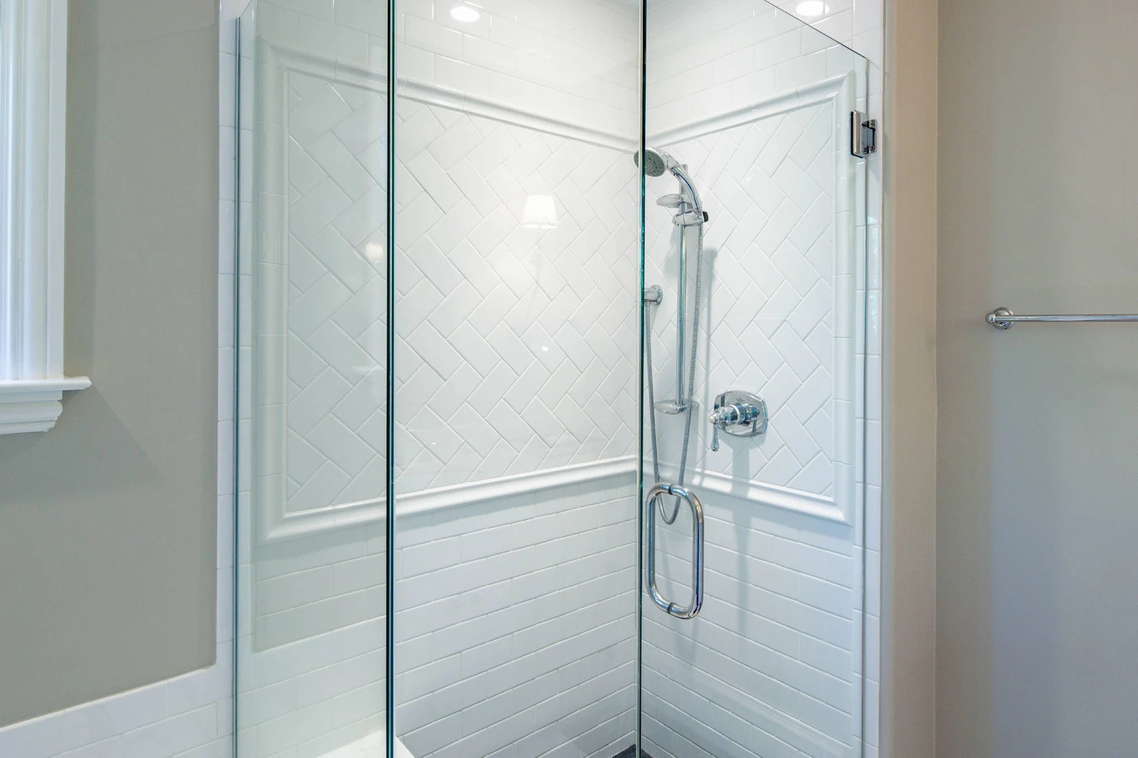 The primary en suite bathroom also has a beautifully tiled, walk-in shower.