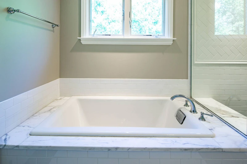 Soak away your stresses and enjoy a good hot bath in this bath tub in the primary en suite bathroom.