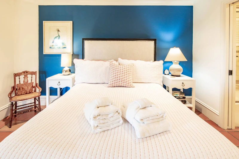 This queen suite has night stands with reading lamps and an en suite bathroom.