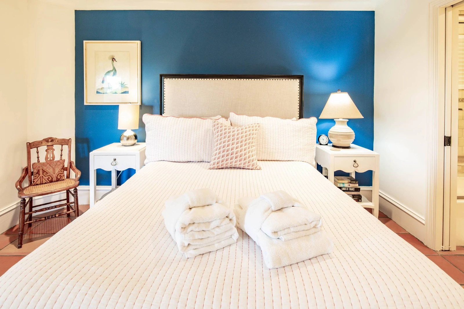 This queen suite has night stands with reading lamps and an en suite bathroom.