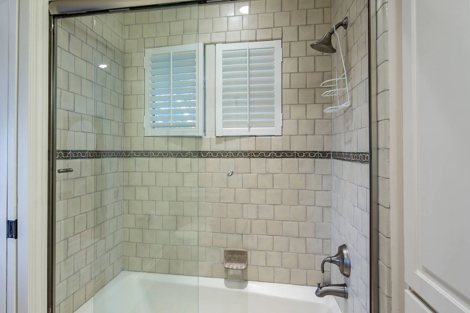 The queen suite has a tiled shower/tub combo.