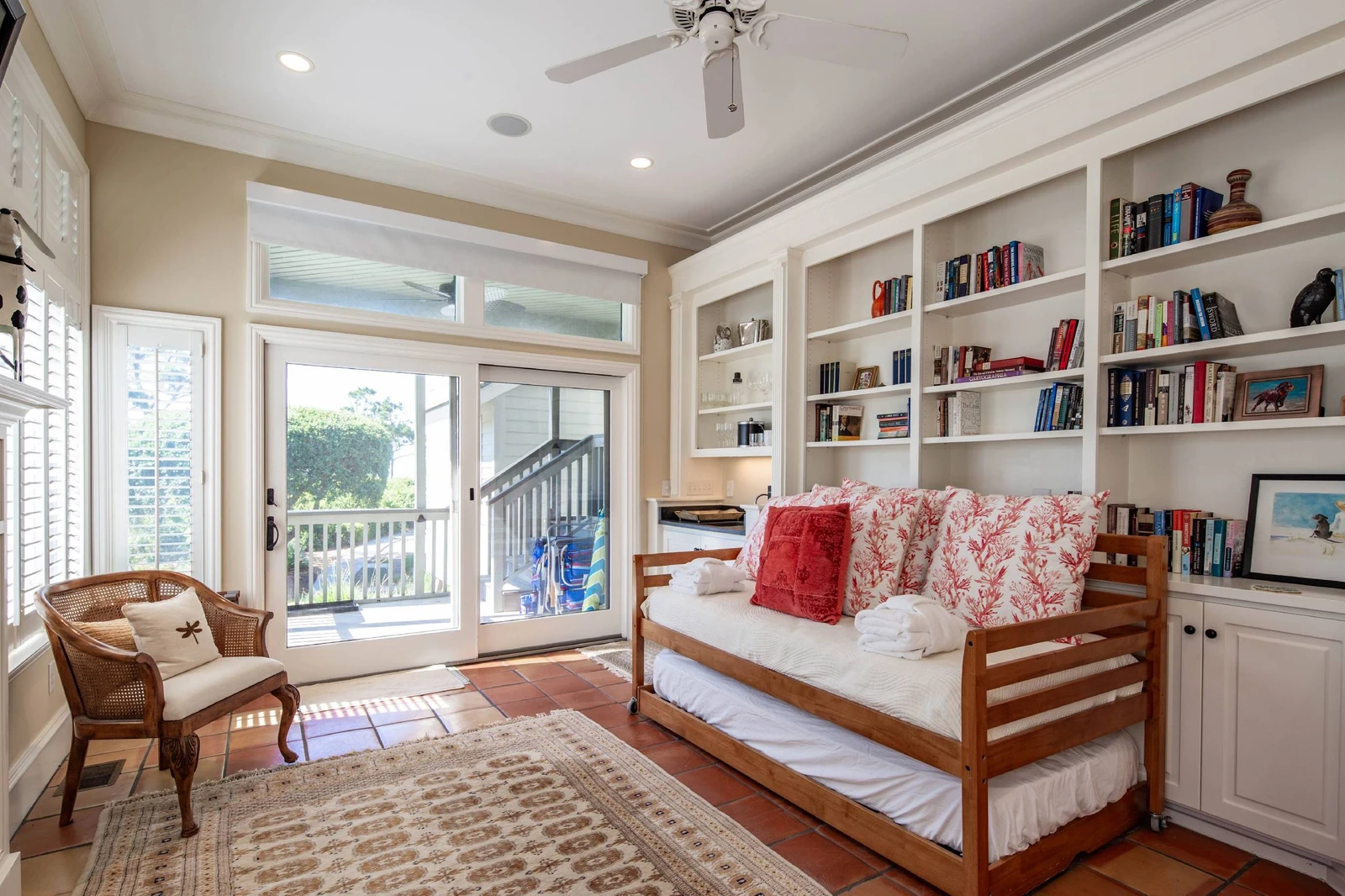 The sunroom, which is on the lower level, features a twin day bed with a trundled twin bed.