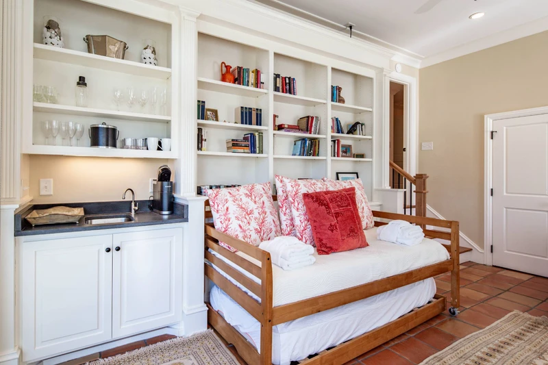 The sunroom also features built-in bookshelves, a keurig coffee bar and a half bathroom.