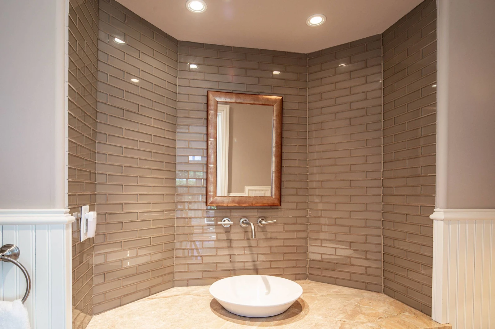 This half bathroom is located in the sunroom.